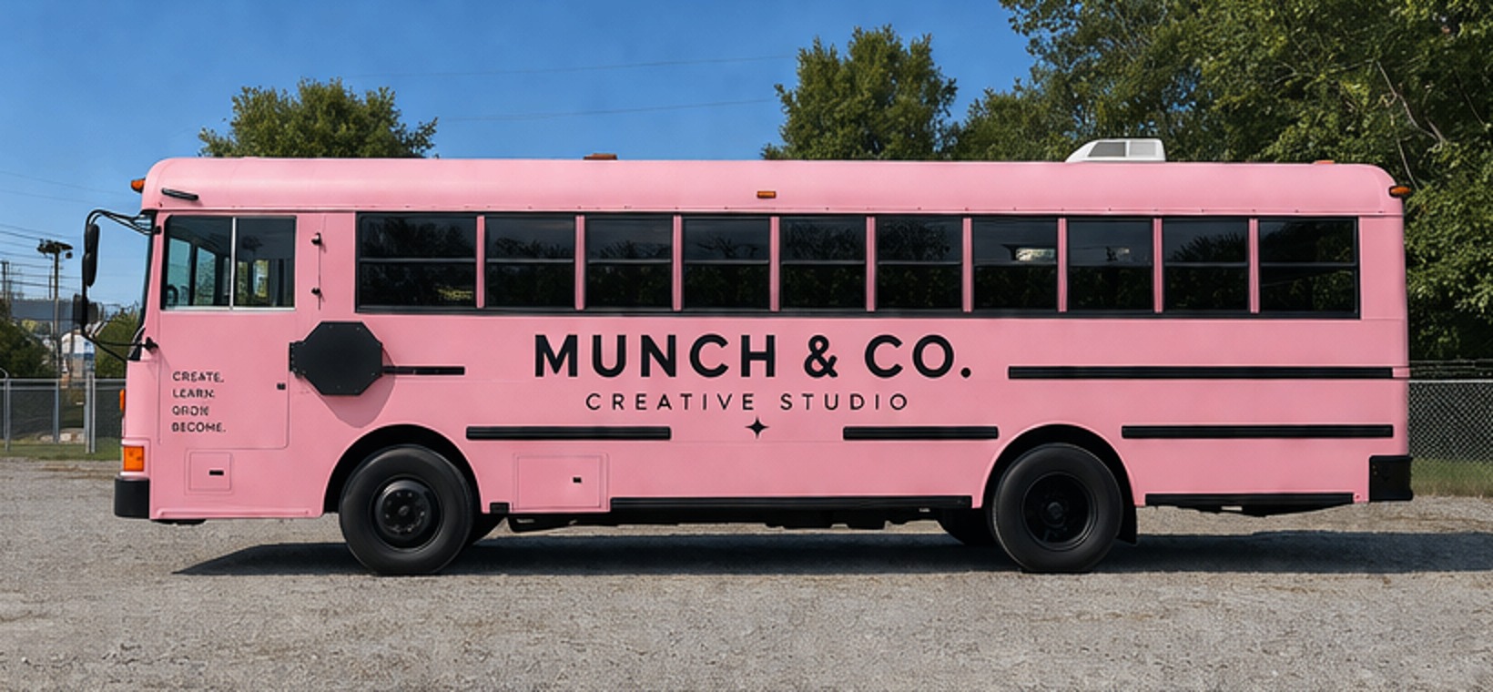 The pink Munch & Co. Creative Studio bus, side view with black lettering